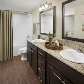 Modern-style double vanity bathroom with bathtub at Camden Farmers Market in Dallas, Tx