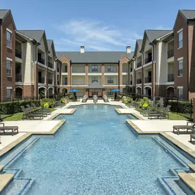 Pool 1 sundeck lined with lounge chairs at Camden Farmers Market apartments in Dallas, TX