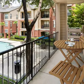 Balcony overlooking pool at Camden Farmers Market Apartments in Dallas, TX