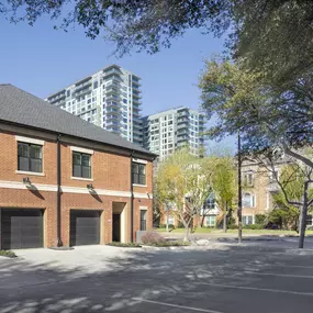 Exterior view of two-story three-bedroom townhomes with attached garages in the heart of downtown at Camden Farmers Market apartments in Dallas, TX