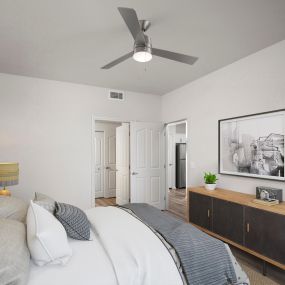 Bedroom with hardwood-style floor, lighted ceiling fan, and ensuite bathroom