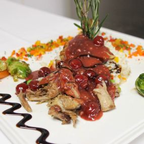 Confit de Canard
Slow roasted duck with thyme pan jus, roasted cherub tomatoes, black beans & sautéed vegetables.