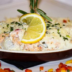 Fruits de Mer
Diver sea scallops, black tiger shrimp & Atlantic Maryland blue crab baked in a white wine basil cream sauce, topped with shaved Asiago cheese and served with jasmine rice & sautéed vegetables.