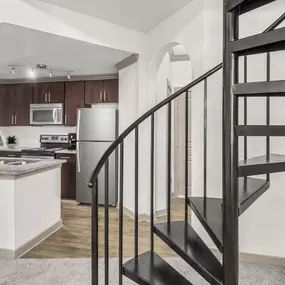 Loft kitchen with spiral staircase to the second level