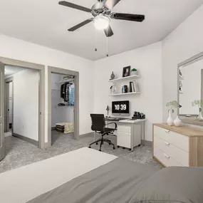 Bedroom with walk-in closet and space to work from home