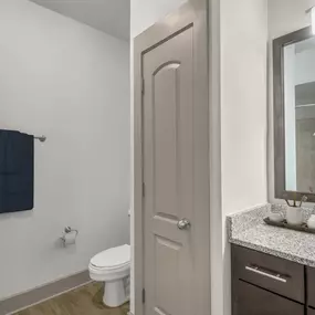 Bathroom with granite countertops and bathtub and shower combination