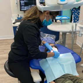 Dentist treating little patient at AS Family dental