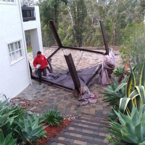 Junk King team member providing a free onsite estimate for a yard cleanup after wild winds in San Diego. We also provide same day junk removal!