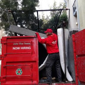 Junk King team member squeezes in one last mattress removal job for a customer. If you ever wondered how to dispose of a mattress, Junk King is here to help!