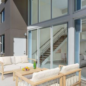 Large patio alongside floor to ceiling windows of the Renoir Townhome at Camden Pier District apartments in St. Petersburg, Florida.