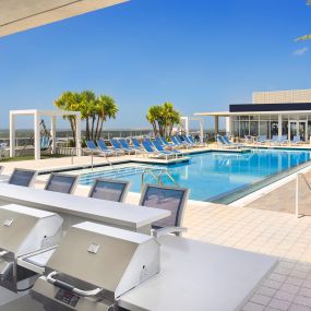 Outdoor oasis in the sky with BBQ grills at Camden Pier District apartments in St. Petersburg, Florida.