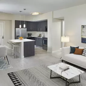 Open-concept living, dining, and kitchen at Camden Pier District high-rise apartments in St. Petersburg, FL