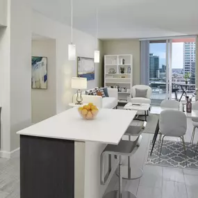 Kitchen, living area, and private balcony at Camden Pier District high-rise apartments in St. Petersburg, FL