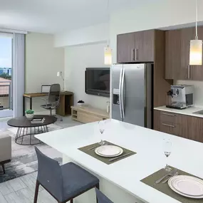 Kitchen and living room with work from home space and sliding glass doors to patio