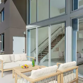 Large patio alongside floor to ceiling windows of the Renoir Townhome at Camden Pier District apartments in St. Petersburg, Florida.