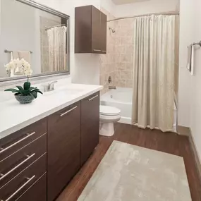 Bathroom with white countertops, a large soaking bathtub and stand up shower