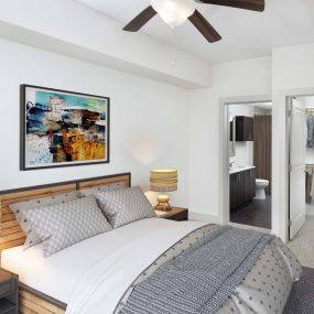 Bedroom with ceiling fan, ensuite bath, and walk-in closet at Camden Boca Raton apartments in Boca Raton, FL