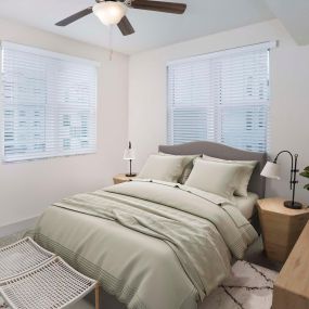 Bedroom with nice natural lighting and lighted LED ceiling fan at Camden Boca Raton apartments in Boca Raton, Florida.