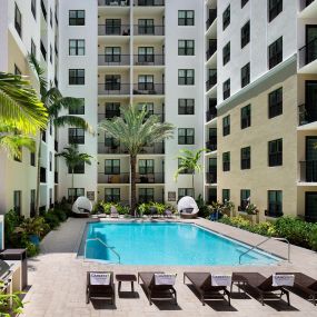 Pool deck with grills and sunbeds.