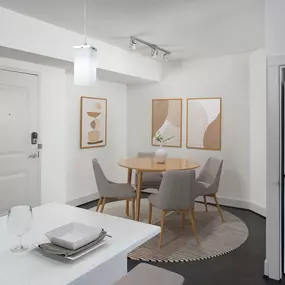 Dining room alongside kitchen and near the full-size, stacked front-loading washer and dryer at Camden Boca Raton apartments in Boca Raton, Florida.