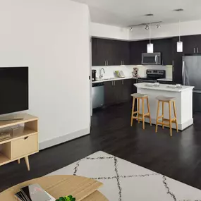 Living room space showing open kitchen concept at Camden Boca Raton apartments in Boca Raton, Florida.