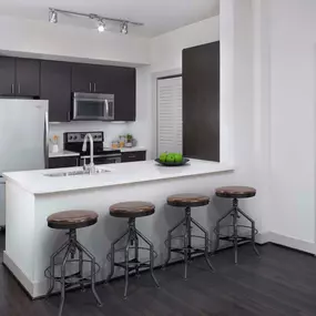 Ktichen with quartz countertop, undermount sink, and stainless steel appliances at Camden Boca Raton apartments in Boca Raton, FL