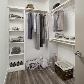 Spacious walk-in closets with wood shelving at Camden Washingtonian apartments in Gaithersburg, MD
