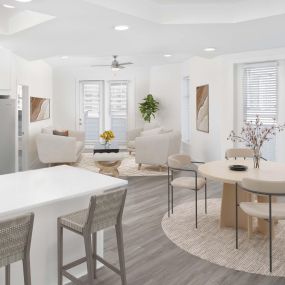 White contemporary apartment dining and living room with open-concept layout at Camden Grandview in Charlotte, NC