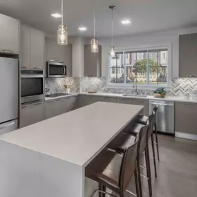 Townhome kitchen with waterfall island and white quartz countertops