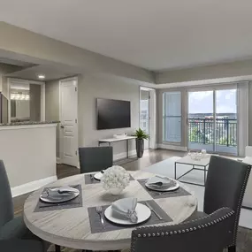 Dining and living room with doors to the balcony