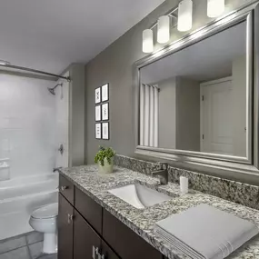 Bathroom with curved shower rod and bathtub