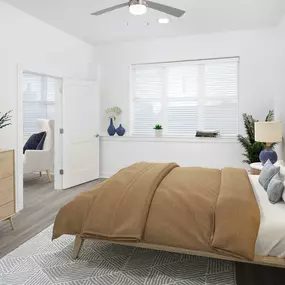 White contemporary apartment bedroom with hardwood-style flooring at Camden Grandview in Charlotte, NC