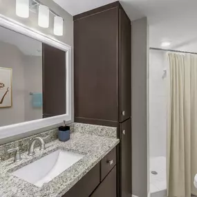 Bathroom with granite countertops and shower