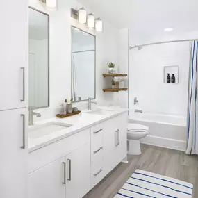 White contemporary apartment bathroom with double vanity at Camden Grandview in Charlotte, NC