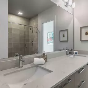 Townhome bathroom with double sink and white quartz countertops