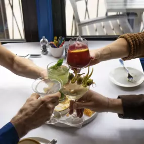 People at table with drinks and food