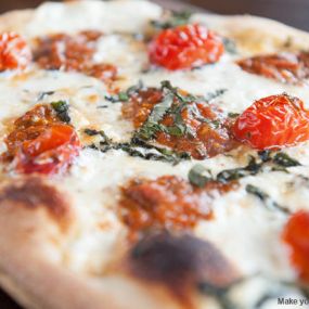 Margherita pizza with fire roasted tomato sauce