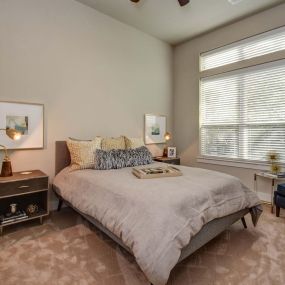 The townhomes bedroom with high ceilings ceiling fan and carpet flooring