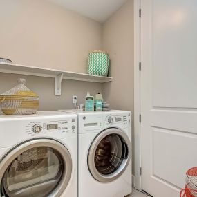 The gallery full-size washer and dryer with shelf in the laundry room