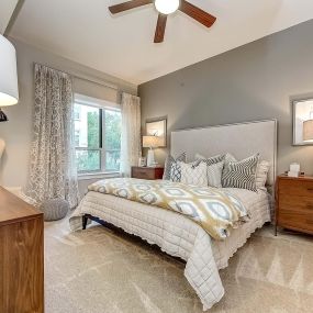 The gallery bedroom with ceiling fan, high ceilings, and carpet flooring
