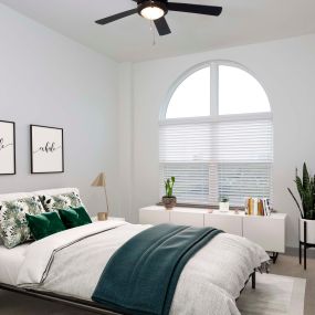 The terrace bedroom with high ceilings, arched windows, and ceiling fans