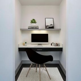 The terrace with a built-in desk area to work from home with wood shelving and a white quartz countertop