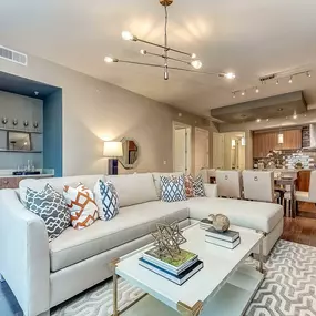 The gallery living room with dry bar and wood flooring