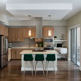 Gallery kitchens with light wood cabinets, subway tile backsplash, and built in desks