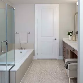 Gallery Bathroom with glass-enclosed shower, large soaking bathtub, tile flooring, and large vanity