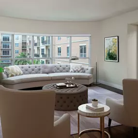 The gallery living area with expansive curved windows and wood flooring