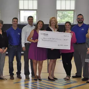 Allstate Helping Hands Foundation presents the Boys & Girls club with a check for $30,000.