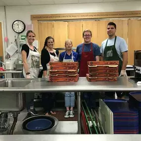 Allstate donates & serves pizza to the homeless during one of their shifts.