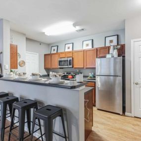 Spacious kitchen with breakfast bar and stainless steel appliances.
