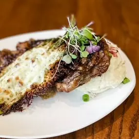 Prepare to savor perfection! Our 12oz ribeye with Bacon jam glaze, loaded mash, and mozzarella roasted asparagus is a taste sensation.